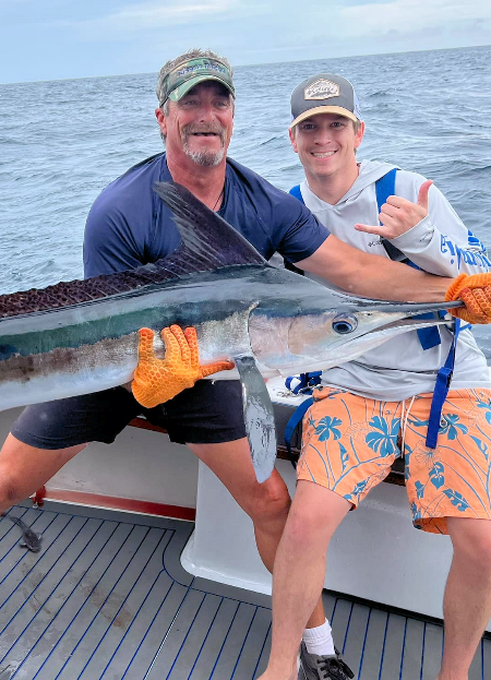 OC angler and mate show off a pretty white marlin just before releasing it.